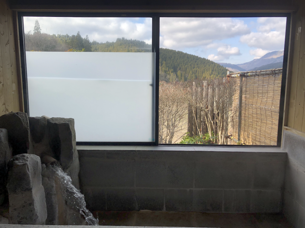 View of the Kuju highlands from inside the bathhouse at Satoyama Onsen Shikisai-no-Yu