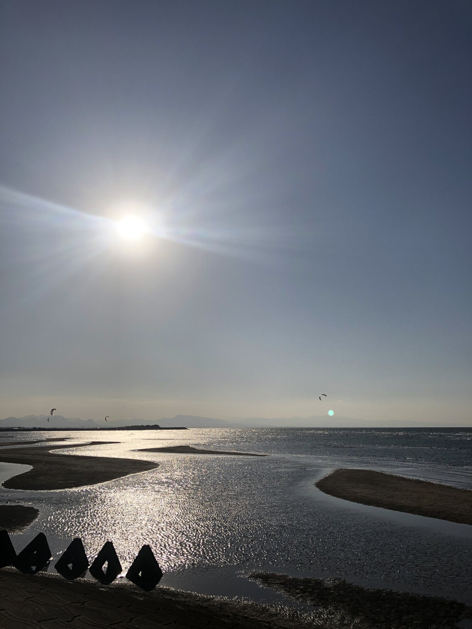 The tidal channel at Matama Coast seen past a row of breakwater blocks